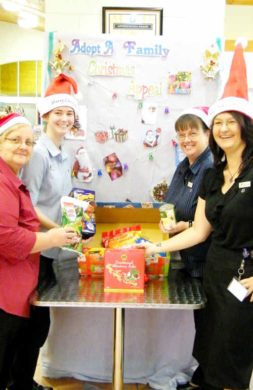 FOOD FOR FINES: Librarian Michelle Stroud (right) is supporting the Adopt-A-Family and Linking Arms for Christmas appeal by waiving fines for overdue items. cont FOOD FOR FINES: Librarian Michelle Stroud (right) is supporting the Adopt-A-Family and Linking Arms for Christmas appeal by waiving fines for overdue items. cont